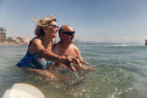 Happy senior couple enjoying playing and splashing in the sea Happy senior woman enjoying summer vacations. Couple is walking in the sea on beach of Alicante.
Canon R5 body positive couple stock pictures, royalty-free photos & images