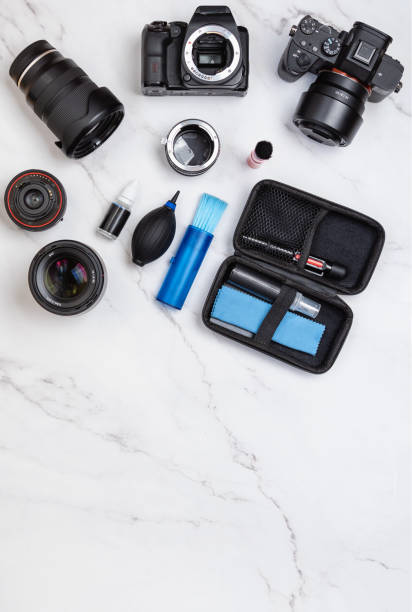 istock White marble workstation for cleaning camera sensor and lenses with copy space on below. Vertical top view 1454632800