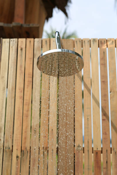 Outdoors shower while running water in the garden.