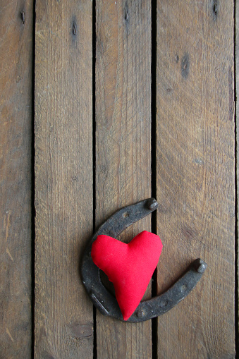 Valentine's Day background. Red heart on a wooden background.