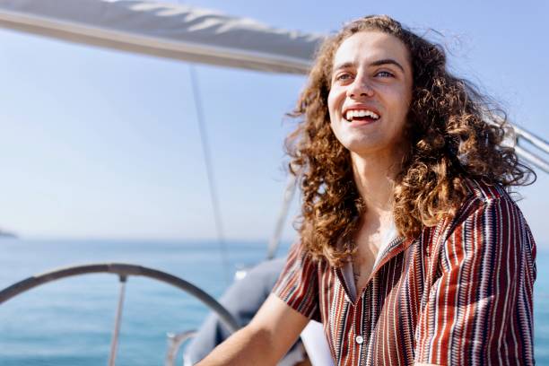 istock Smiling man sailing yacht on a sunny day 1454635719
