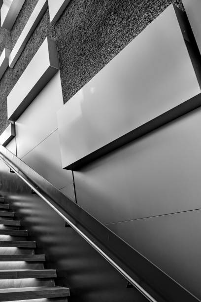 istock Vertical grayscale shot of a modern architecture stairway 1454635764