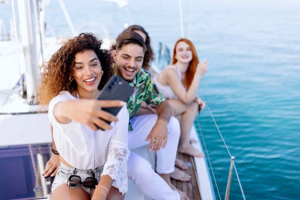 istock Friends taking selfie while sailing on the yacht 1454636034