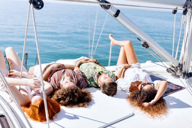 istock Young friends relaxing and having a good time on yacht 1454636624