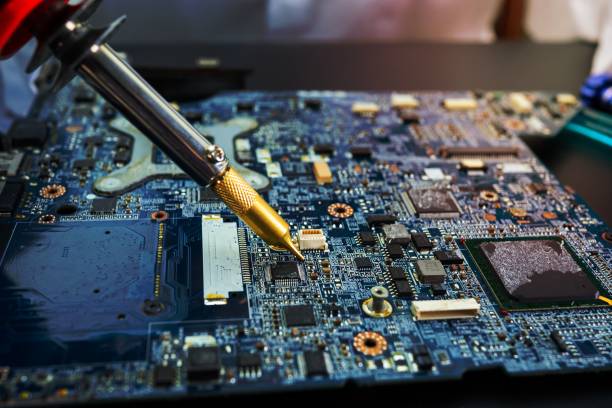 istock E-waste, technician repairing inside of hard disk by soldering iron. Integrated Circuit. the concept of data, hardware, technician and technology. 1454637224