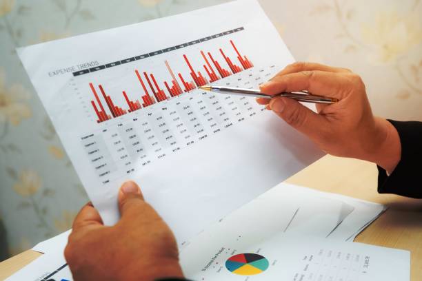 istock Asian accountant working and analyzing financial reports project accounting with chart graph and calculator in modern office, finance and business concept. 1454638590