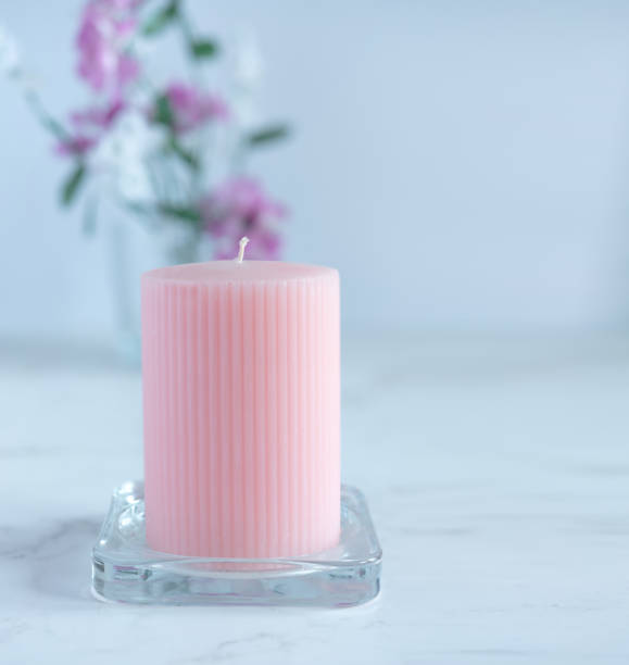 istock unlit pink candle on floral background 1454639367