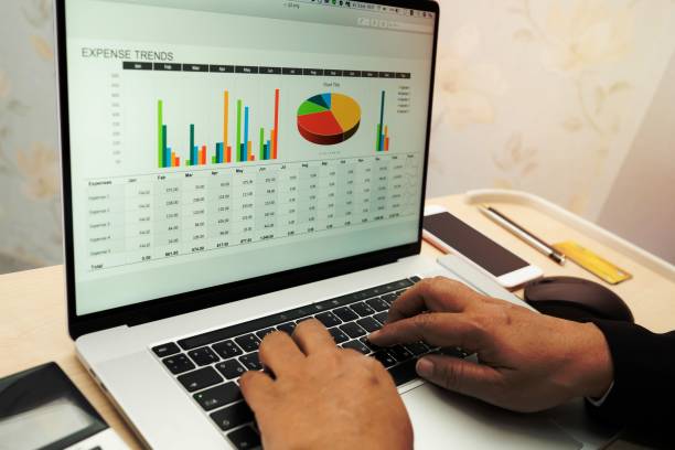 istock Asian accountant working and analyzing financial reports project accounting with chart graph and calculator in modern office, finance and business concept. 1454639403