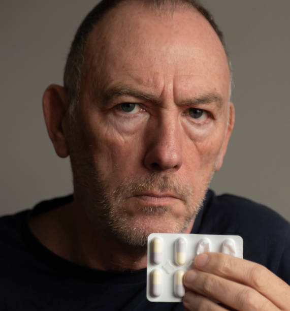istock Senior man suffering with cold and flu symptoms 1454639423