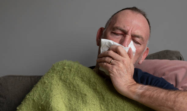 istock Senior man suffering with cold and flu symptoms 1454640010