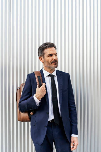 istock Mature businessman with backpack on street 1454640062