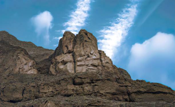 istock Low-angle of sunlit rocky cliffs against a clear sunlit sky 1454640930