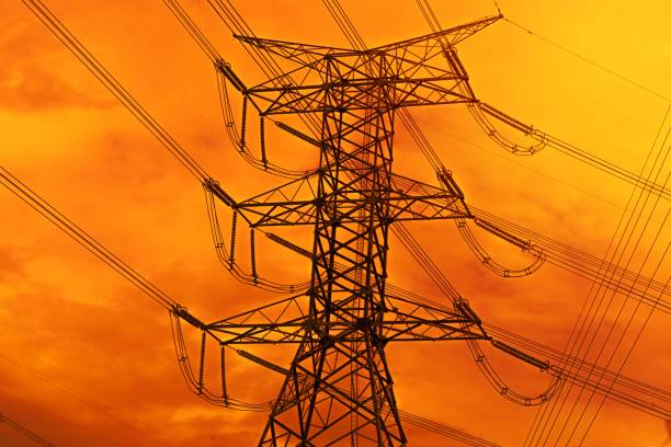 istock High voltage electric pole with power line electricity engineer distribution station in sunset. 1454646630