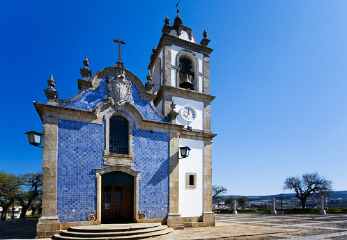 Bell tower and main building of Igreja do Calvario, Vila Real, Portugal. Traditional tiled facade. 17th century.