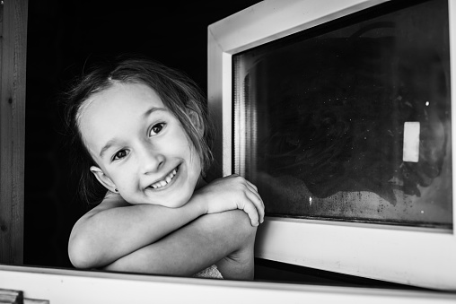 The little girl opened the window after the bath because she felt very hot in the steam room