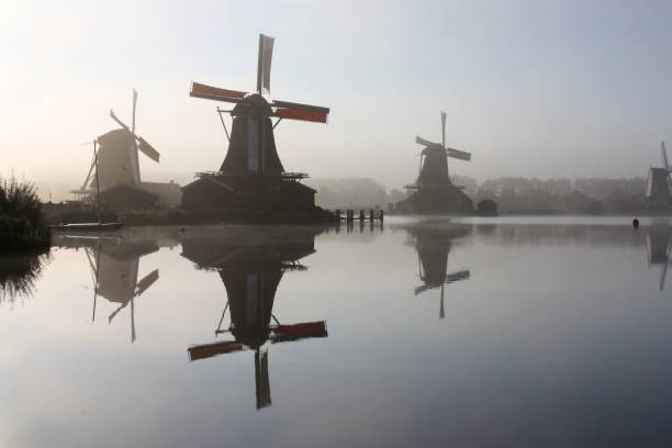 istock windmills in the morning mist 1454651083