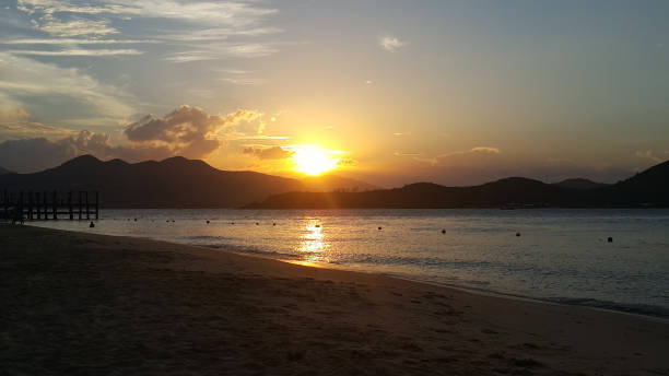 istock Beautiful sunset or sunrise over sea and mountains 1454652482