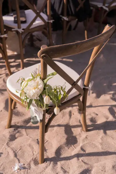 White flowers, arch, glasses. Beautiful wedding decor, blue sky sand sea