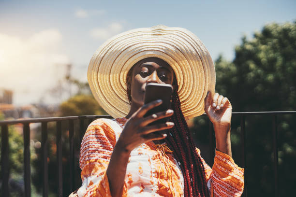 istock Black girl using phone outdoors 1454652940