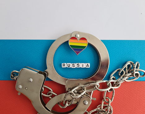 Ban Russia and rainbow flag and handcuffs. LGBT conflict and rights concept. Metaphor Russia against LGBT community
