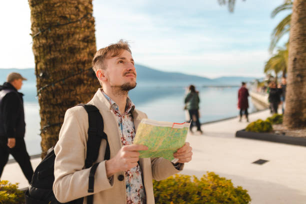 istock Lost young tourist looking at the map while on a summer vacation 1454660018