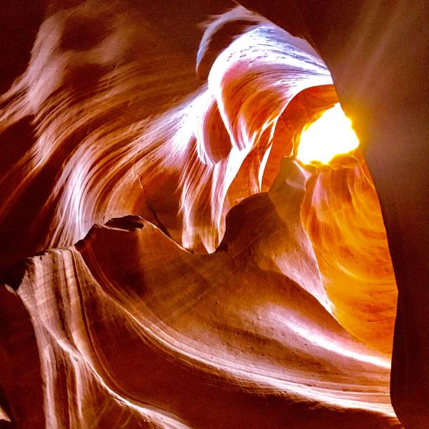 Discover the breathtaking Antelope Canyon in Arizona, USA, featuring stunning sandstone formations shaped by wind and water over time. This iconic slot canyon showcases mesmerizing light beams, smooth curves, and vibrant red rock walls, creating a surreal maze and otherworldly landscape.