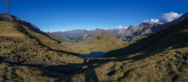 Panorama of beautiful mountain lake Lac des Especieres ou de Luhos in the Pyrenees on a sunny autumn day, Gavarnie, Nouvelle-Aquitaine, France