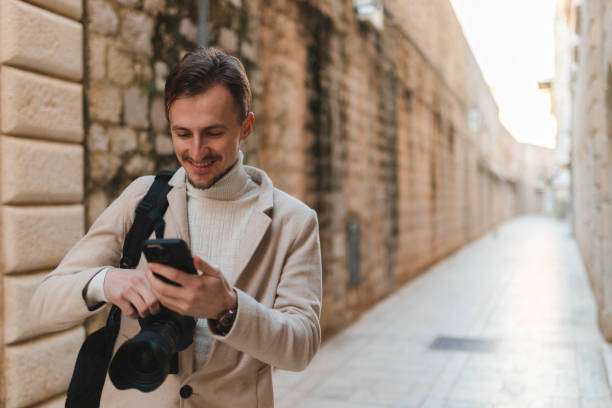 istock Young male tourist using his phone while visiting old town Dubrovnik 1454661406