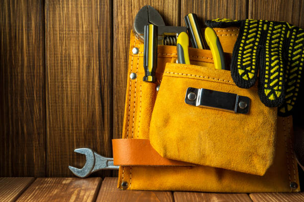 istock Tools and instruments in leather bag isolated on wooden background. 1454661595