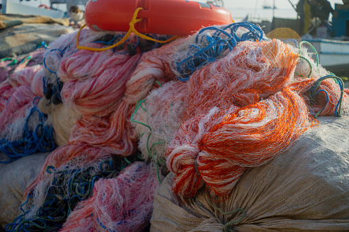 View of folded fishing net at shore.