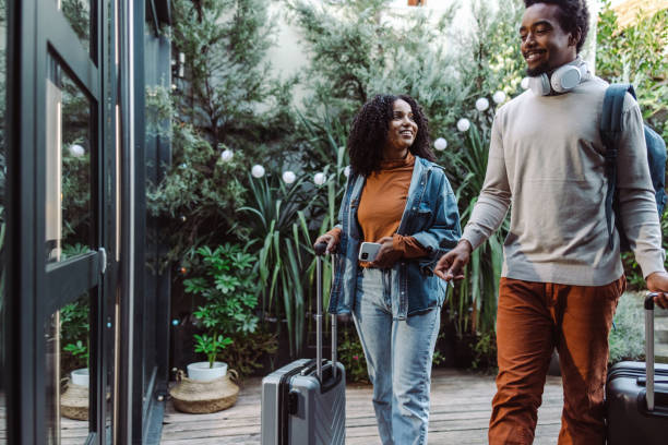 African-American tourists with suitcases stock photo