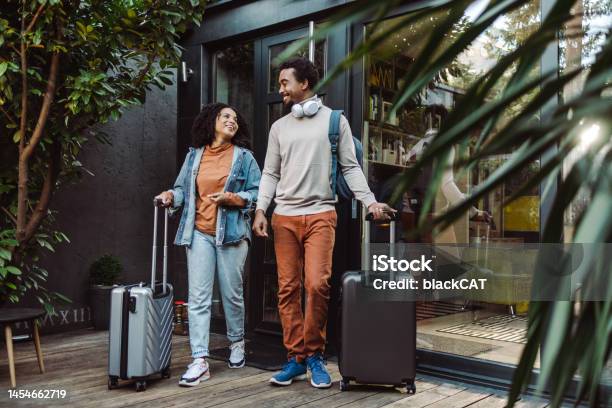 Africanamerican Tourists With Suitcases In Front Of The Rented Apartment Stock Photo - Download Image Now
