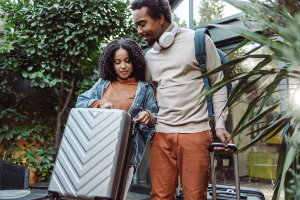 istock African American tourists checking suitcase before trip 1454662779