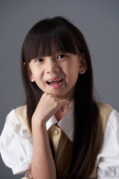 istock Young woman thinking and looking at camera , isolated on gray studio background 1454663692
