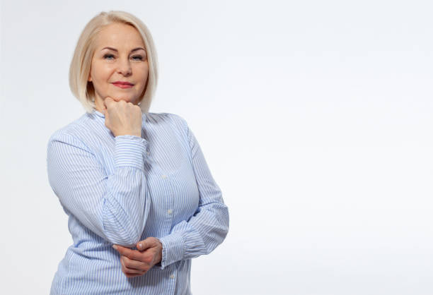 istock Attractive middle aged woman with folded arms on white background 1454663727