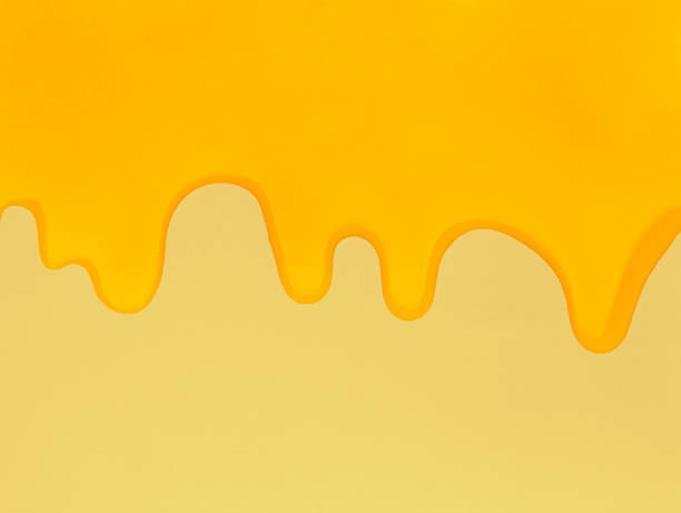 istock Pouring honey on a yellow background. 1454665835