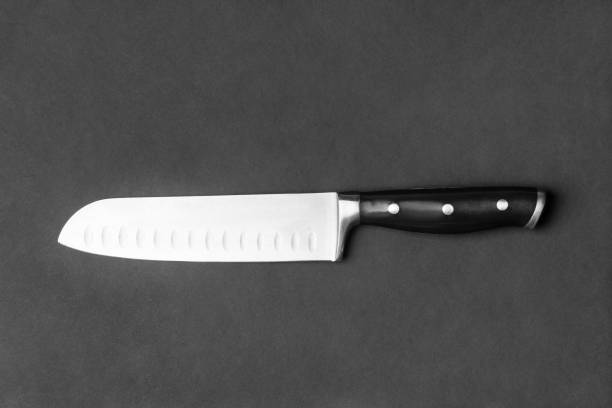 istock Large kitchen knife on a black background top view 1454665970