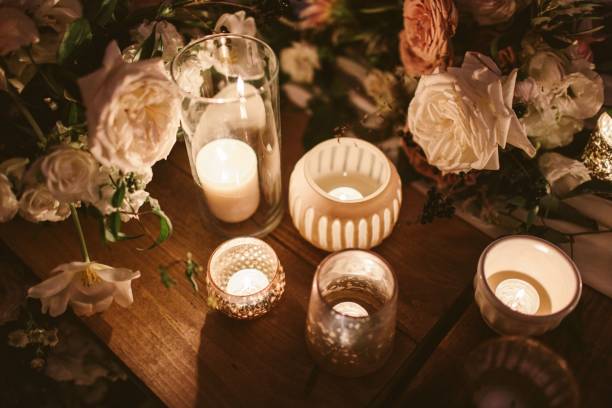 istock Candle and flowers decoration on a wooden table 1454670815