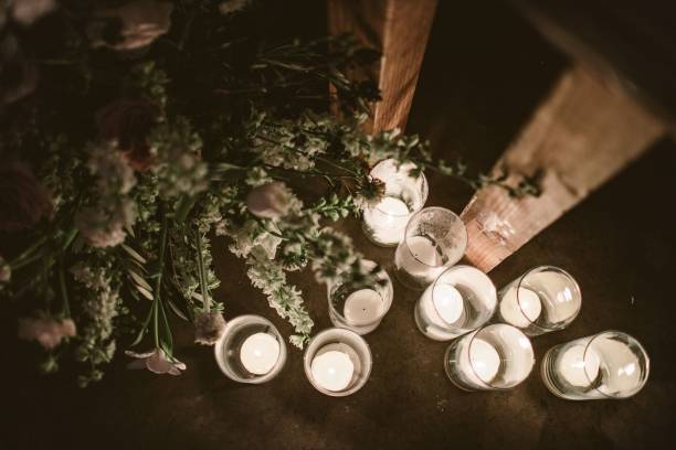 istock Candle and flowers decoration on a wooden table 1454670820