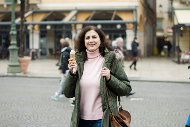 istock Woman is eating ice cone in winter town 1454671675