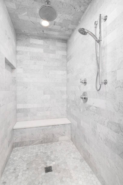 istock A shower with marble tiles and chrome faucet. 1454675516