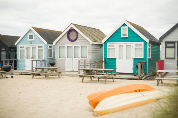 istock Wooden beach huts on seaside in summer. Dorset, UK 1454675661
