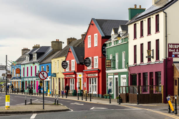 A colorful street in downtown Dingle, Dingle Peninsula, Ireland. Dingle is a town in County Kerry, Ireland. The only town on the Dingle Peninsula, it sits on the Atlantic coast, about 50 kilometres (30 mi) southwest of Tralee and 71 kilometres (40 mi) northwest of Killarney. Principal industries in the town are tourism, fishing and agriculture. dingle peninsula stock pictures, royalty-free photos & images