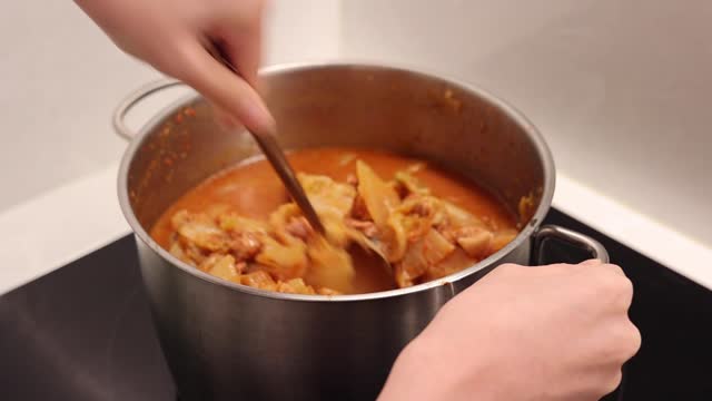 Cooking kimchi stew with a pot