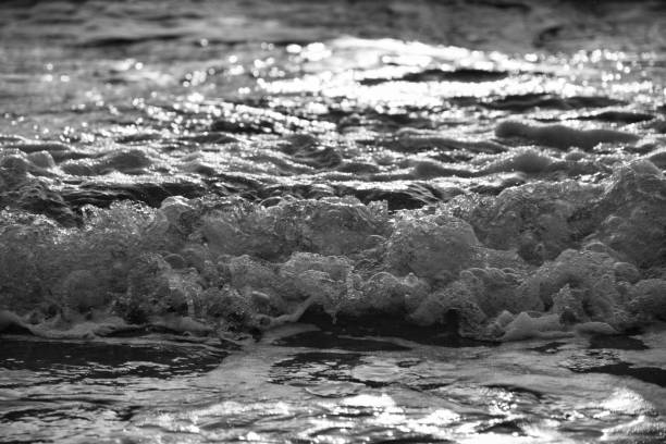 Sea waves crushing on shore. White sea foam.