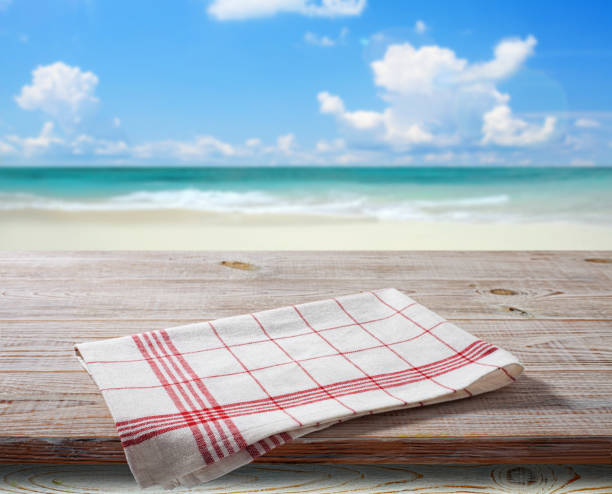 istock White napkin, table cloth on wooden deck mockup. 1454681306