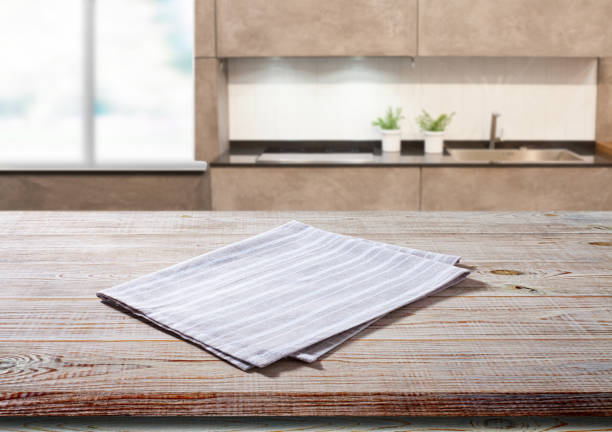 istock White napkin, table cloth on wooden deck mockup. Kitchen interior background 1454681309