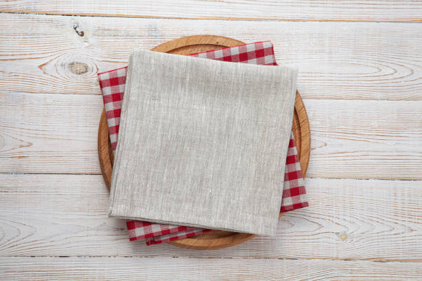 istock Empty pizza board and napkin on white wooden top view. 1454681491