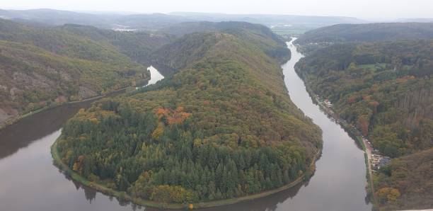 istock Mesmerizing landscape view with green dense trees surrounded by a river 1454681679