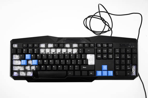 istock Broken black keyboard with blue and black buttons close up top view 1454682015